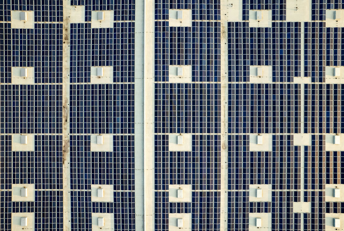 Solar panels arranged in a grid on a rooftop.